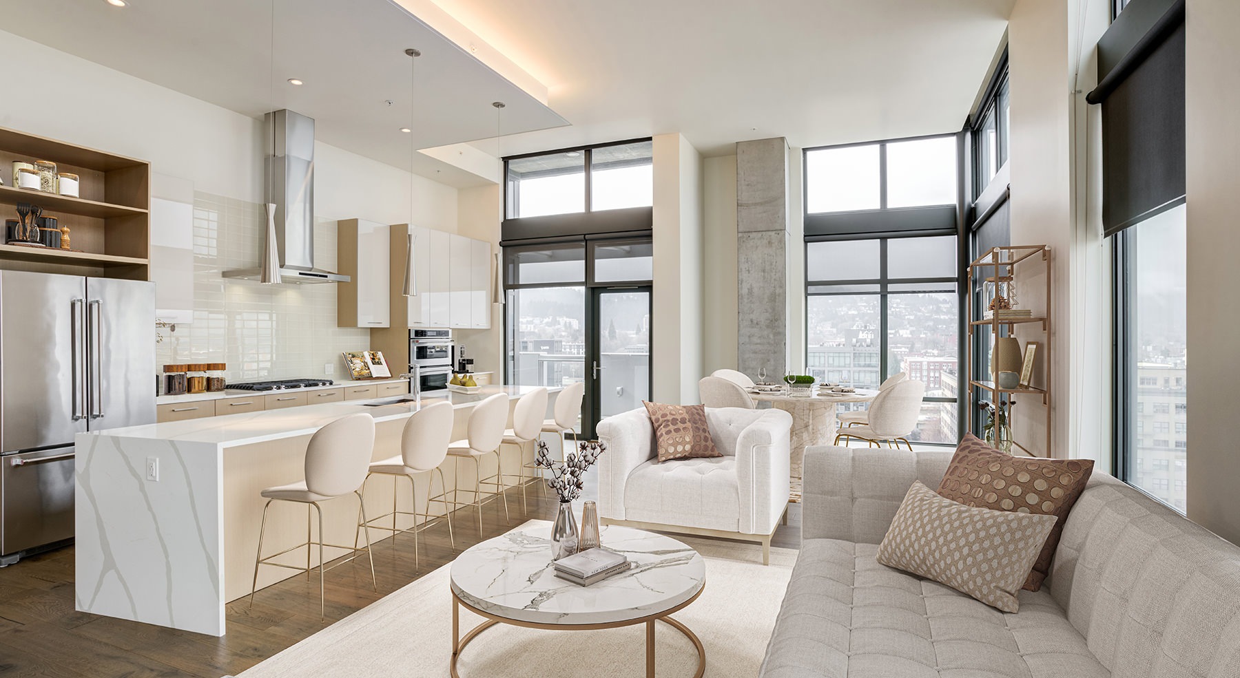 Spacious well lit living room with large floor to ceiling windows 