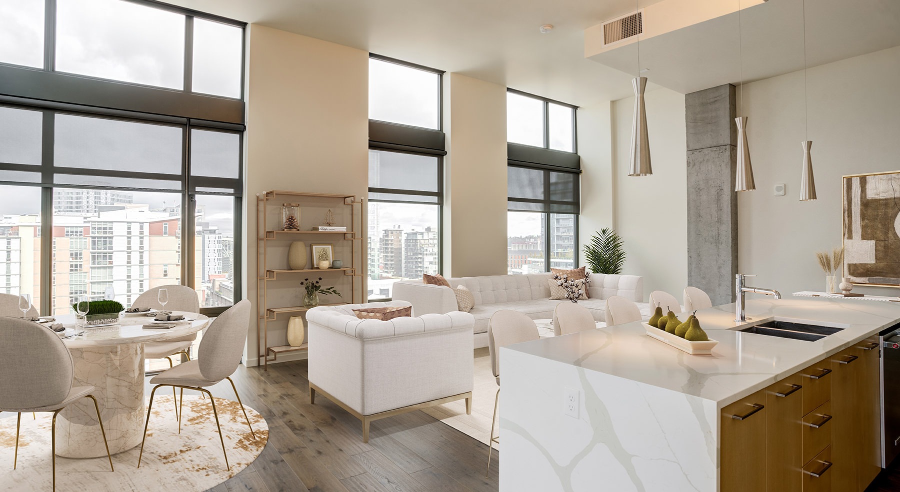 Spacious and well lit kitchen with wood floors and stainless steel appliances