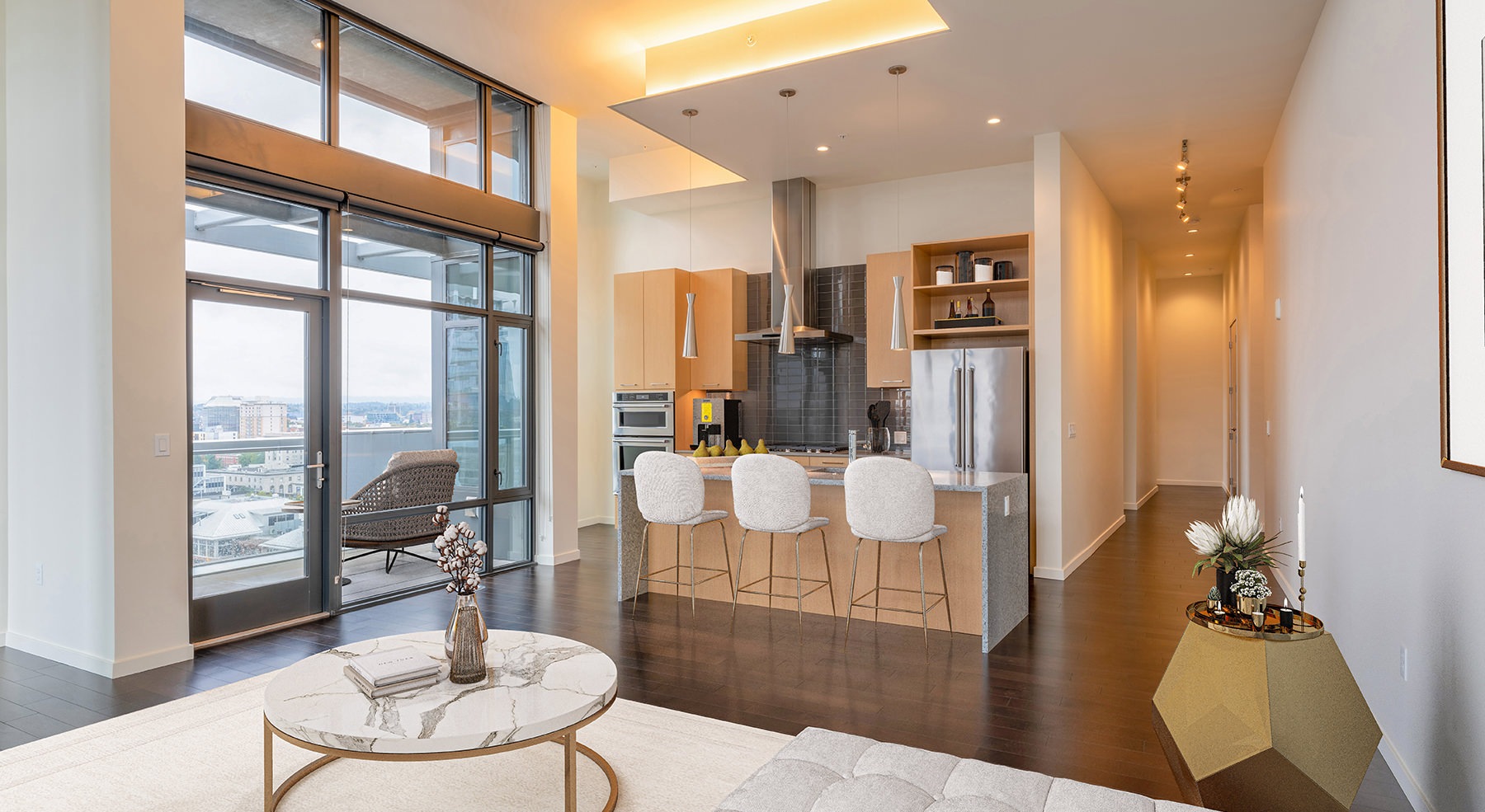 Spacious and well lit kitchen with wood floors and stainless steel appliances