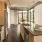 Spacious and well lit kitchen with wood floors and stainless steel appliances. 