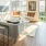 Spacious and well lit living room with wood floors and an open floor plan with access to the kitchen.