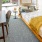 Spacious and well lit bedroom with plush carpet and large windows