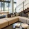 Spacious and well lit lounge with large windows and plenty of seating 