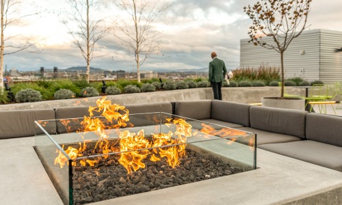 Rooftop firepit with seating and a view of the city