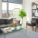 Spacious and well lit living room with wood floors and an open floor plan with access to the kitchen.