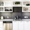 Spacious and well lit kitchen with wood floors and stainless steel appliances. 