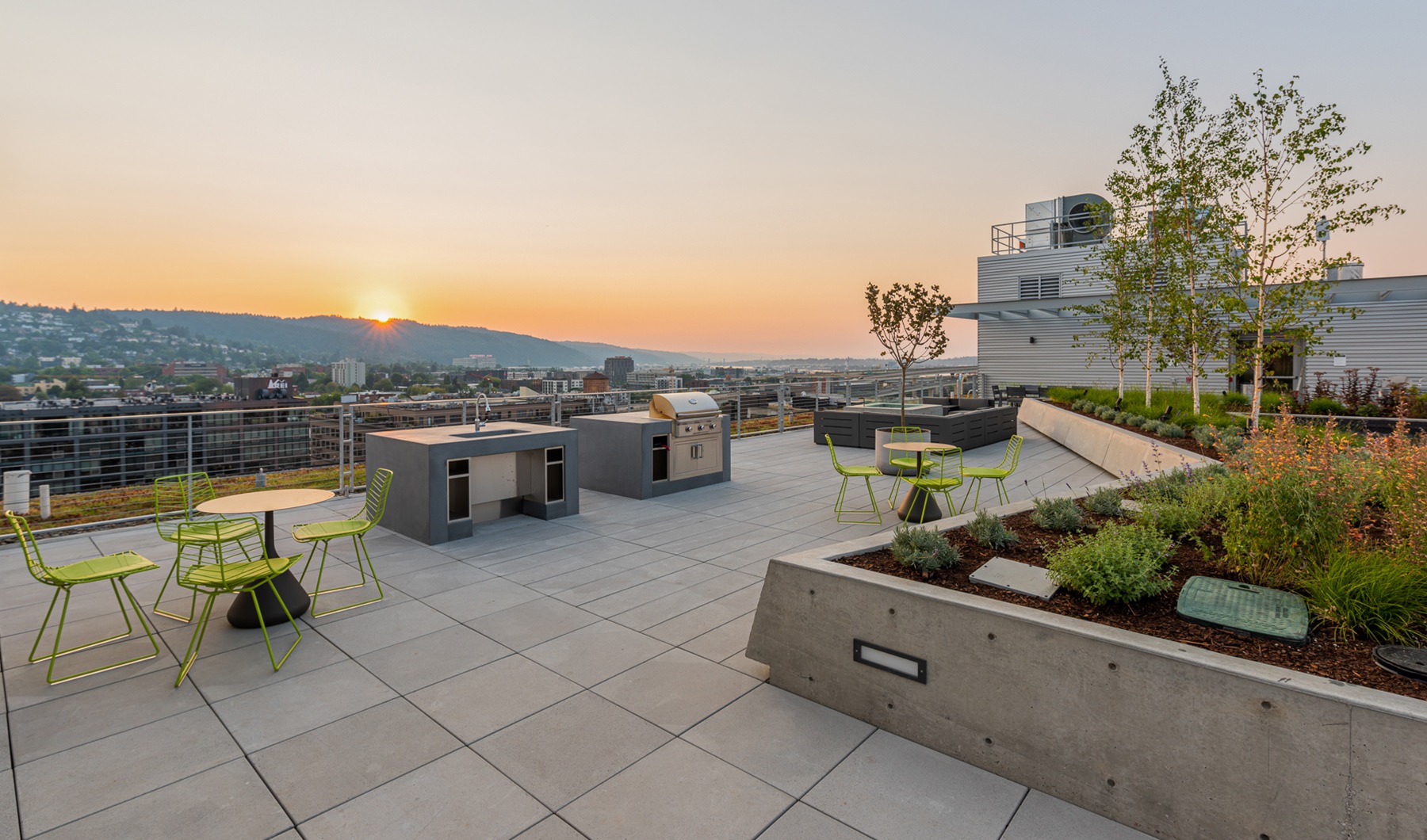 Large rooftop patio with BBQ area and a view overlooking Portland