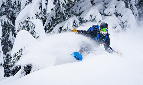 Person snow boarding in fresh snow 